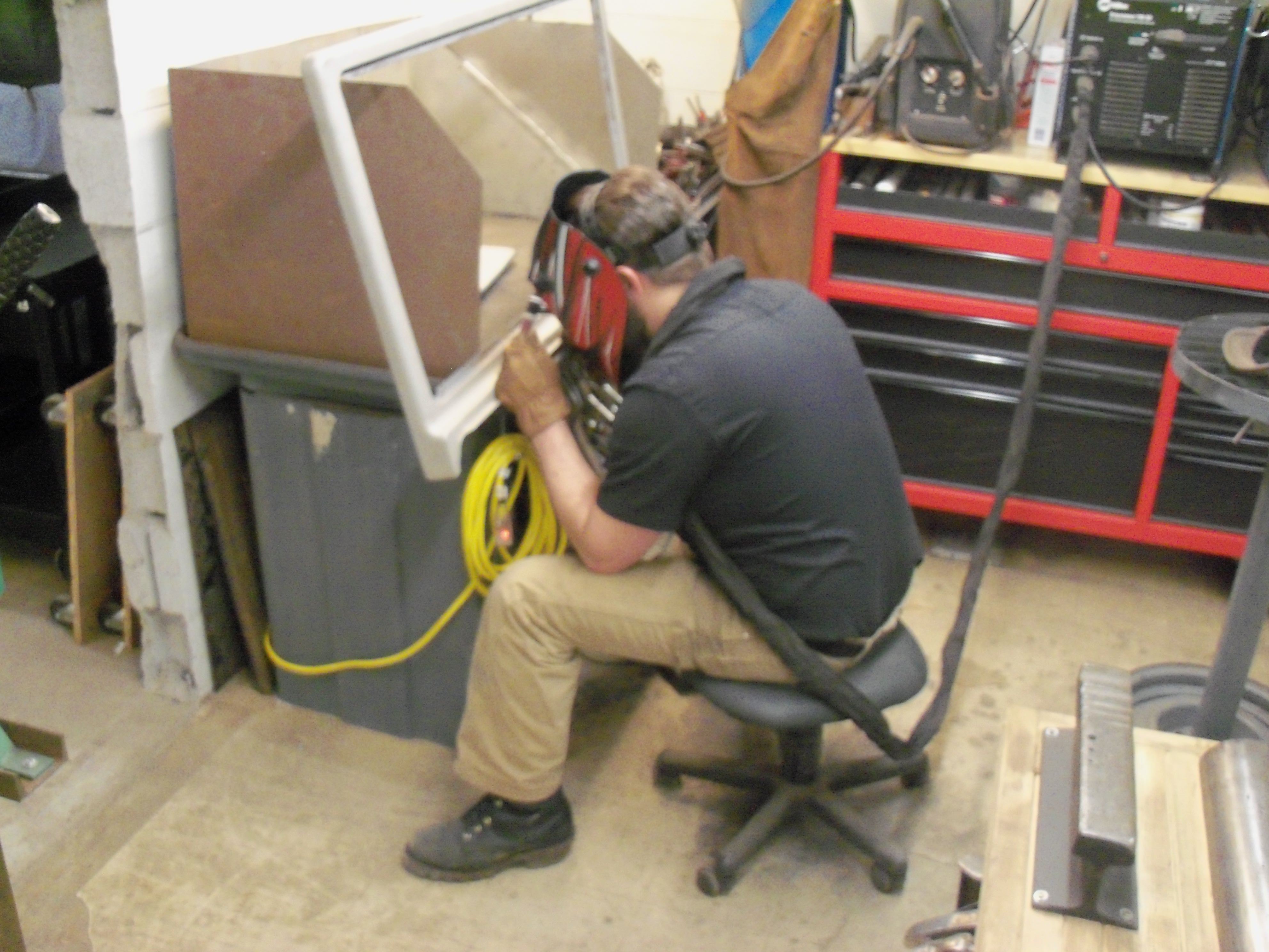 Vintage appliance repair technician working on small appliance